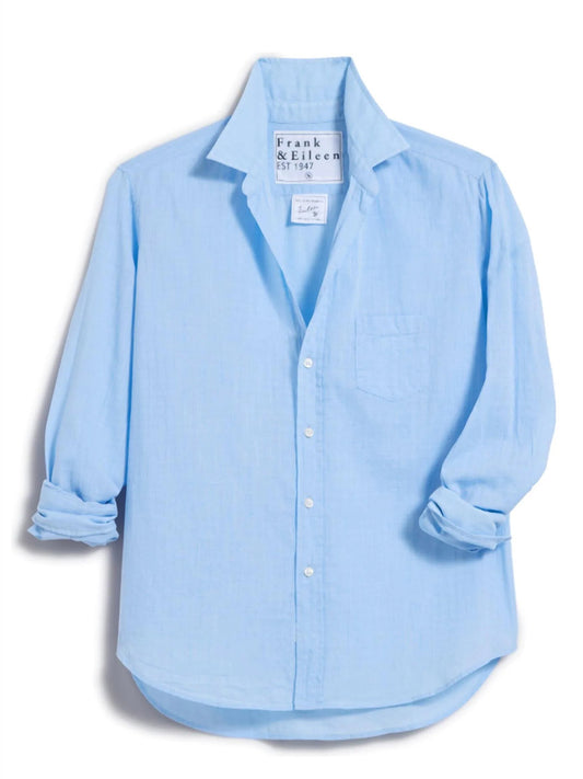 The Frank & Eileen Eileen Relaxed Button-Up Shirt in Textured Blue features a light blue 100% cotton Italian chambray, relaxed fit, front pocket, rolled sleeves, and a visible Frank & Eileen label inside the collar.