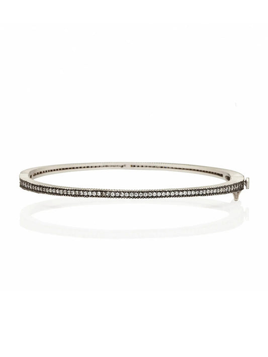 A thin, Freida Rothman The Classic Pavé Hinge Bangle in Black & Silver adorned with small, evenly spaced pavé stones on a white background.