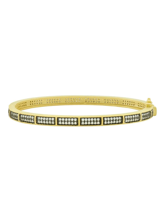 Freida Rothman Pavé Hinge Bangle in Black & Gold with a row of cubic zirconia set in a channel, isolated on a white background.