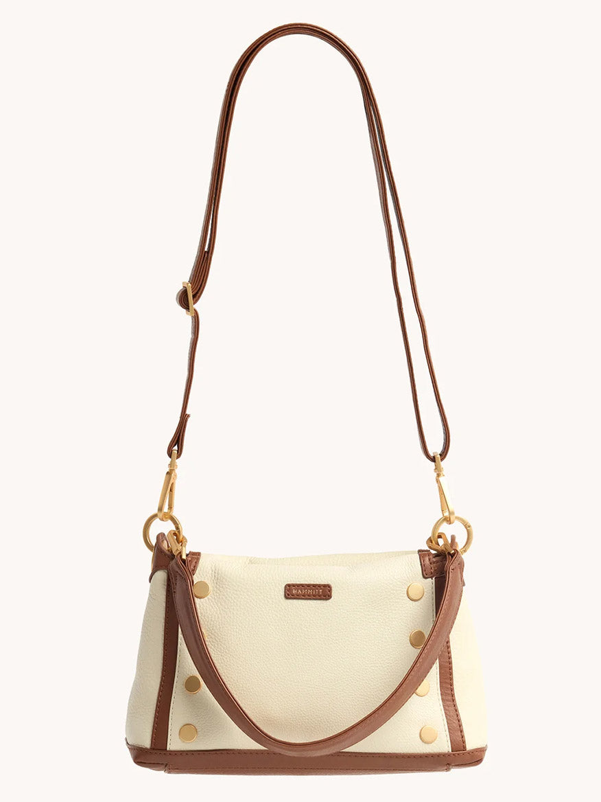 The Hammitt Los Angeles Bryant Medium Crossbody Bag in Courtyard Cream features brown pebbled leather trim, gold-tone hardware, and an adjustable shoulder strap, shown against a plain white background.