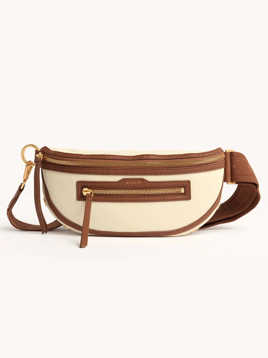 The Hammitt Los Angeles Charles Crossbody Medium in Courtyard Cream features cream and brown pebbled leather, gold zipper and hardware, adjustable strap, and a front zip pocket.