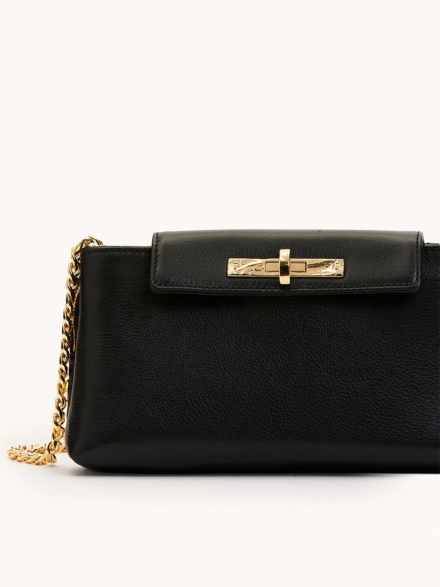The Hammitt Los Angeles Charlotte Small in Black/Gold features black pebble leather, a gold chain strap, and a gold clasp on the front flap, displayed against a plain background.