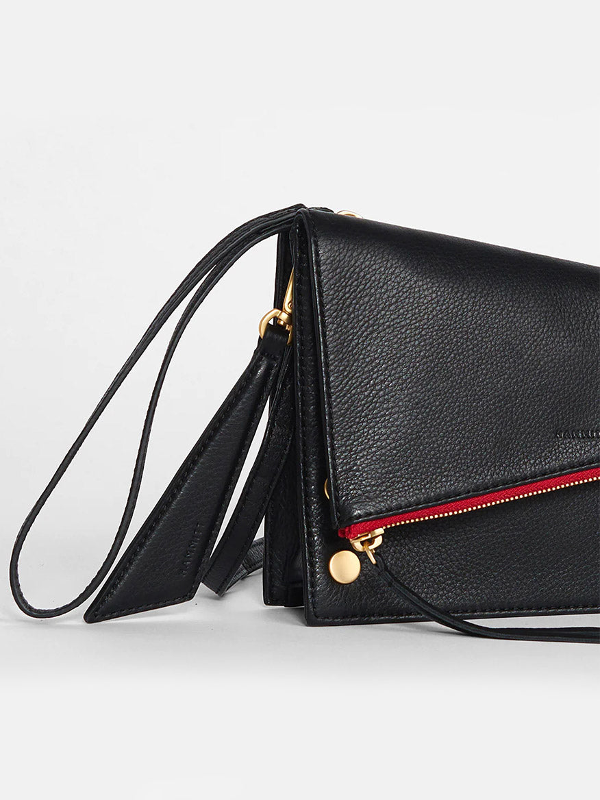 Hammitt Los Angeles Curtis in Black & Red Zip leather crossbody bag with a gold zipper and a thin strap, featuring a detachable hangtag, displayed against a plain white background.