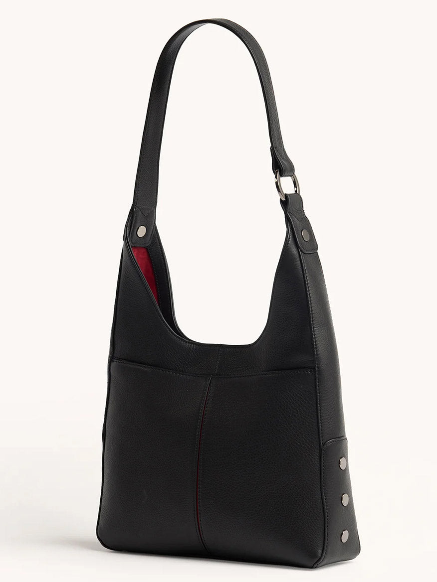 The Hammitt Los Angeles Tim Hobo in Black is a pebbled leather shoulder bag featuring a single strap, front pocket, visible stitching, silver side rivets, magnetic closure, and a red interior lining.