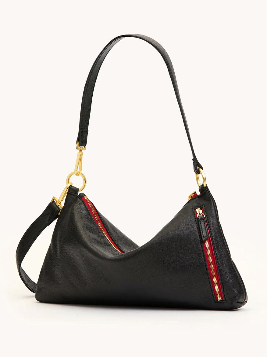 The Hammitt Los Angeles Kyle Medium Shoulder Bag in Black/Brushed Gold/Red Zip features a pebble leather finish, brushed gold hardware, red-accented zippered pockets, and a short strap for versatile crossbody or shoulder wear.