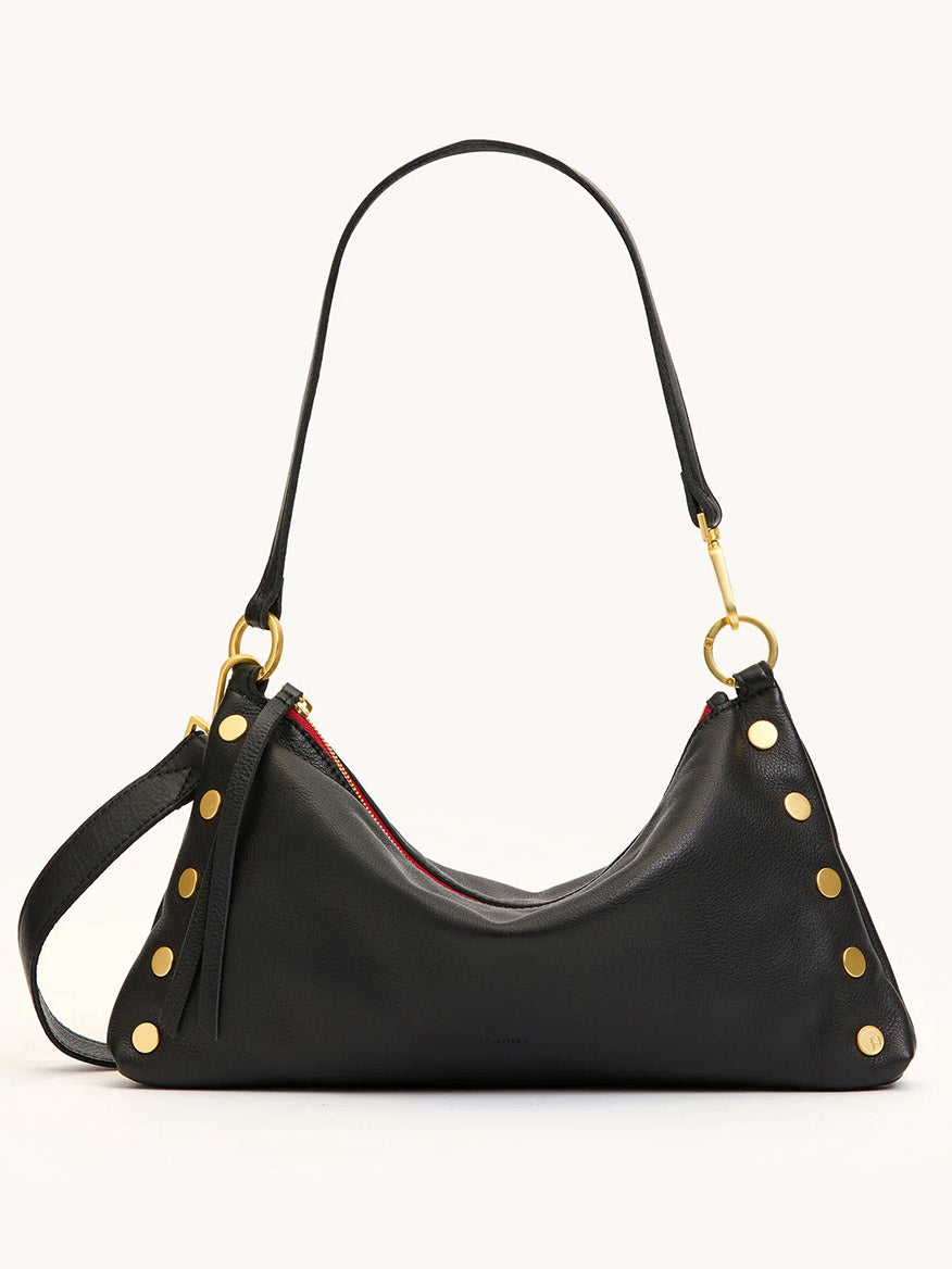 The Hammitt Los Angeles Kyle Medium Shoulder Bag in Black/Brushed Gold/Red Zip features black pebble leather, gold studs, a short handle, adjustable crossbody strap, and a red zipper—uniting standout style with versatile function.