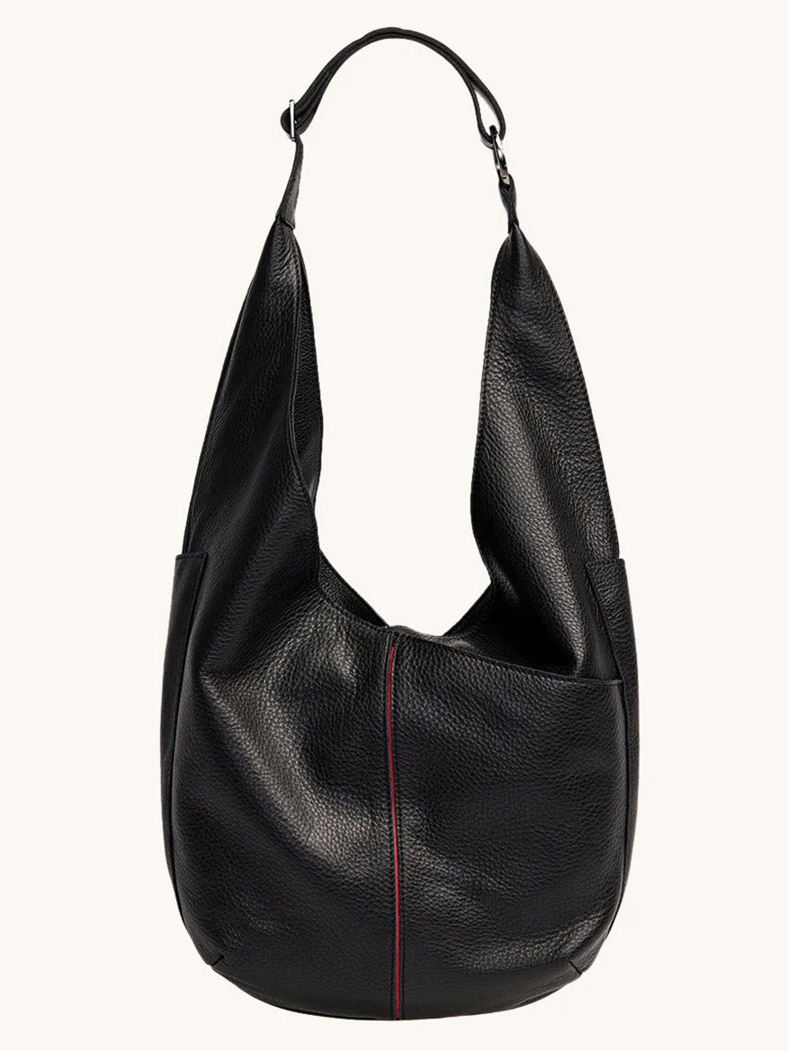 The Hammitt Los Angeles Tom Zip Large in Black/Gunmetal is a spacious black pebbled leather shoulder bag with a single wide strap, textured surface, and a subtle vertical red seam on the front.