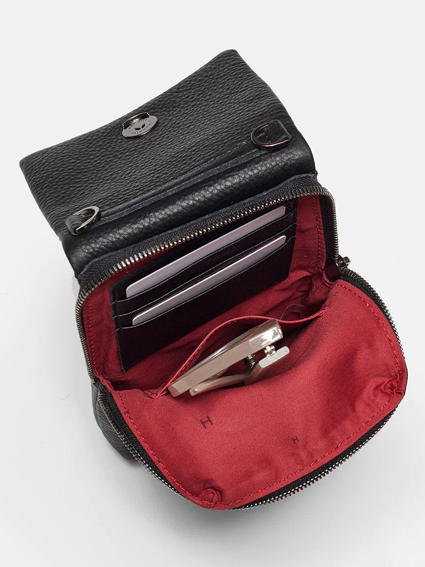The Hammitt Los Angeles VIP Mobile in Black/Gunmetal features black pebbled leather, a red interior with card slots, and a compact mirror—ideal for organizing essentials in your crossbody bag.
