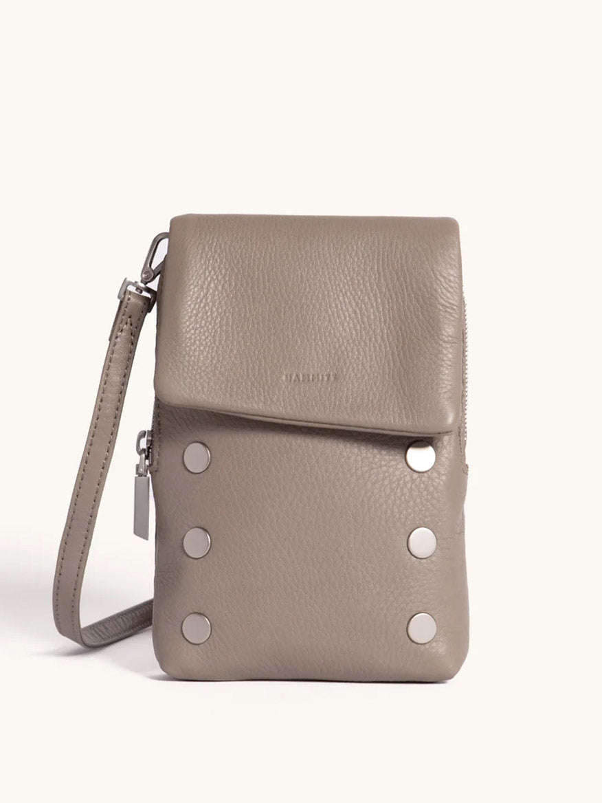 Meet your new favorite: the Hammitt Los Angeles VIP Mobile in Pewter/Brushed Silver, featuring pebbled leather, a fold-over flap, silver hardware, six round front studs, wrist strap, and a convenient cellphone pocket.