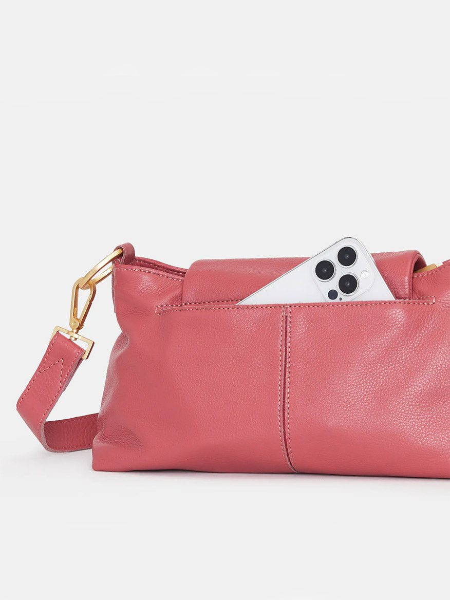 A white smartphone protruding from a Hammitt Los Angeles VIP Satchel in Rouge Pink with a magnetic cell pocket closure on a plain white background.