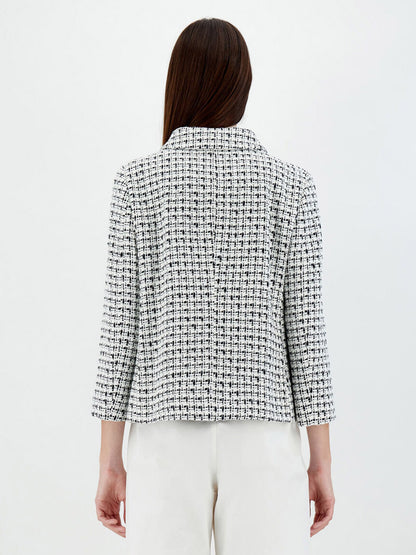 Rear view of a woman wearing a Herno Trend Tweed Jacket in White and white pants, standing against a plain white background.