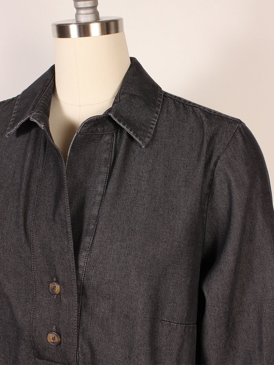 A close-up of the Hinson Wu Aileen 3/4 Sleeve Denim Shirt in Black Wash with buttons, made from premium fabric and showcased on a dress form against a simple backdrop.
