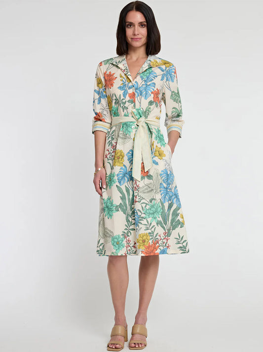 A woman stands wearing a Hinson Wu Charlie 3/4 Sleeve Rainforest Multi Print Dress, paired with beige sandals against a plain background.