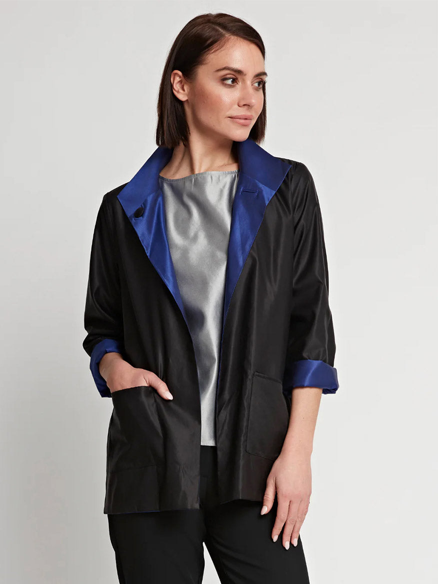 A woman wearing the Hinson Wu Constance Reversible Long Sleeve Silk Satin Jacket in Royal/Black.