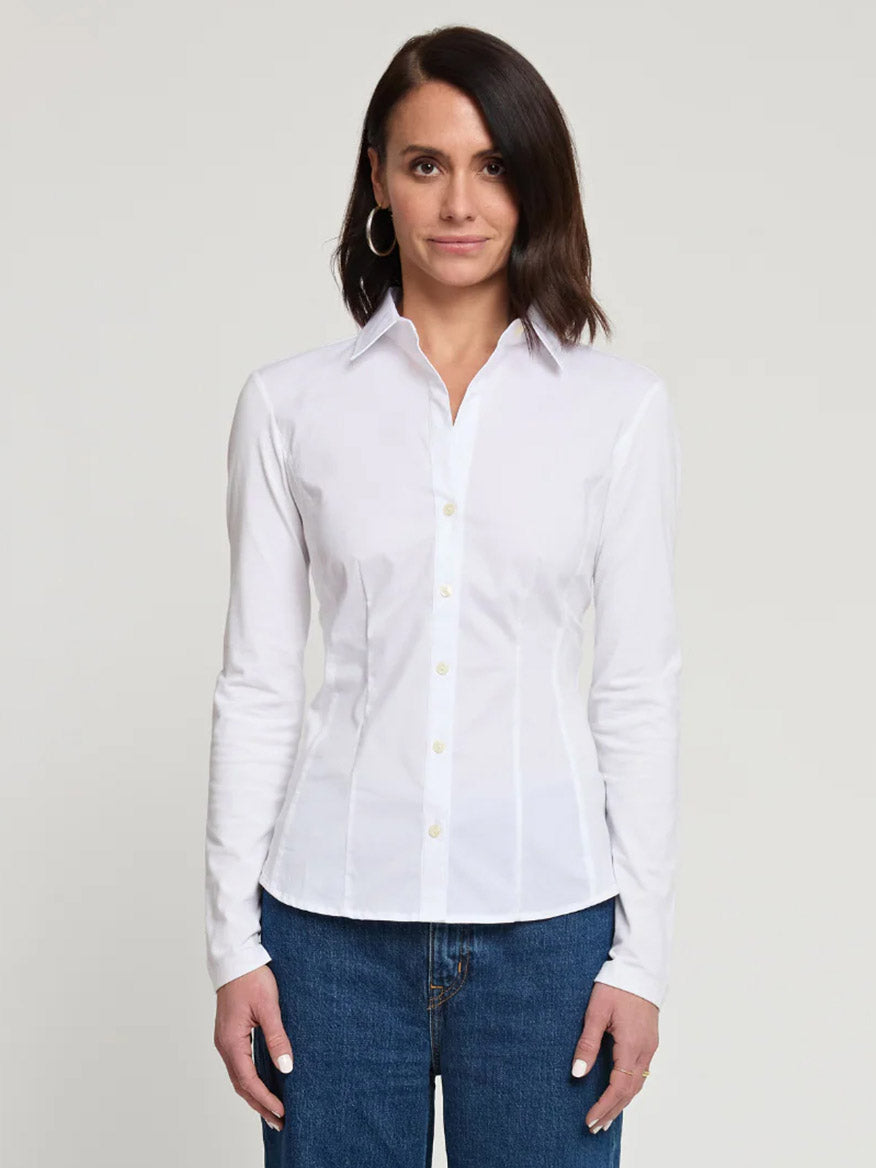 A woman faces forward against a plain light background wearing the Hinson Wu Jamie Long Sleeve "T" Shirt in White and blue jeans.