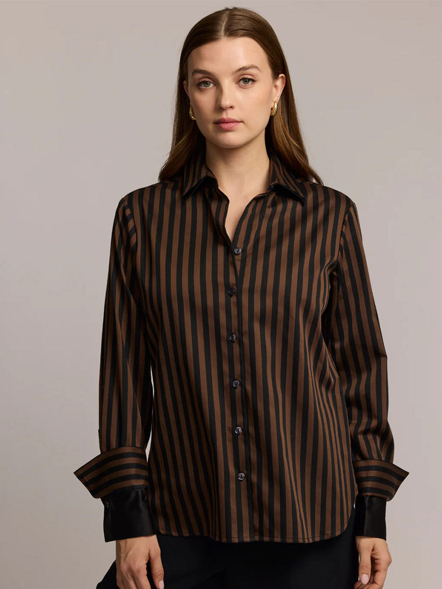A woman stands facing the camera against a plain background, wearing the Hinson Wu Margot Long Sleeve Lace Print shirt in Caramel/Black.