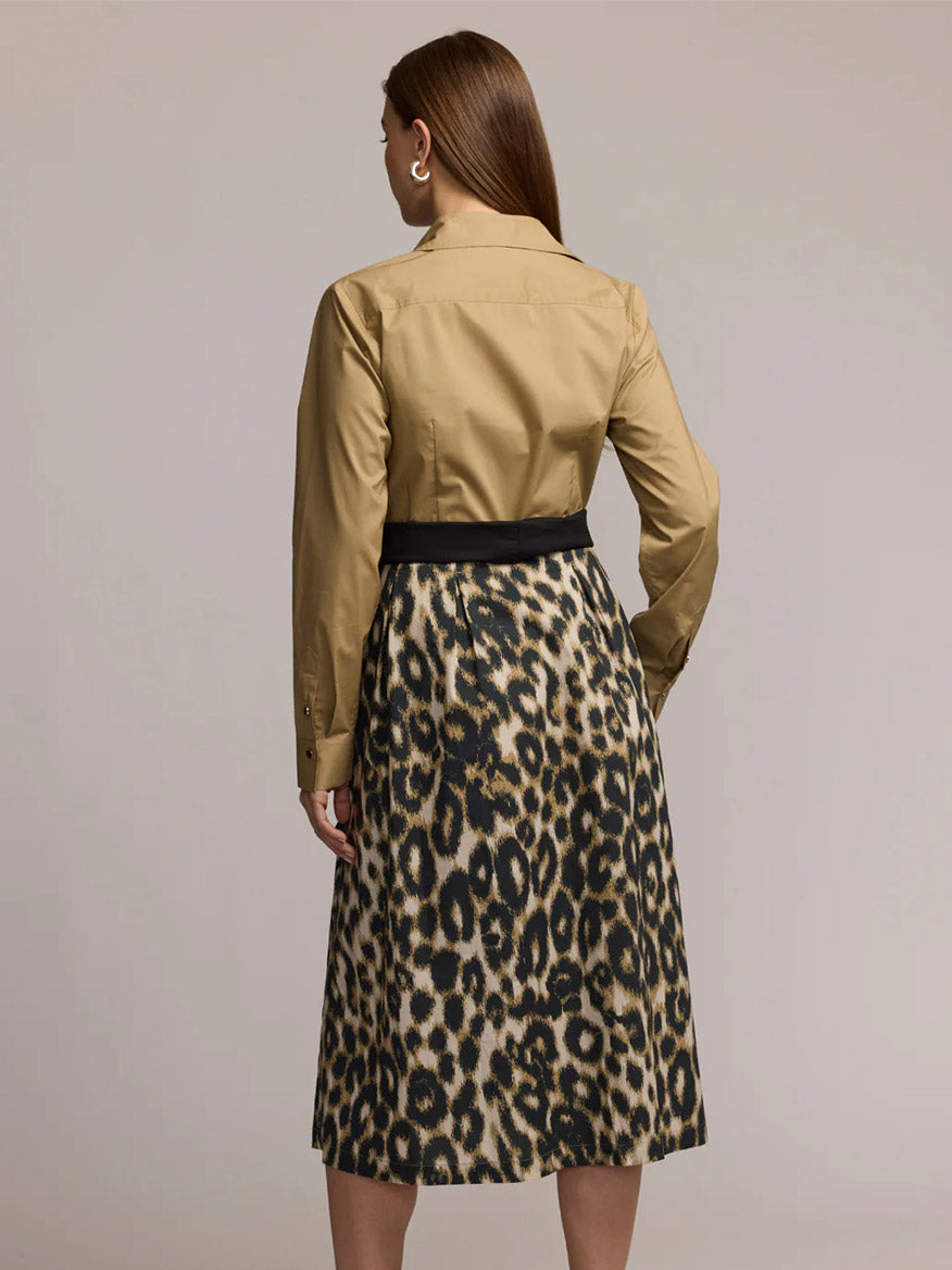 A woman stands facing away, wearing the Hinson Wu Robin Long Sleeve Animal Print Dress in Khaki.