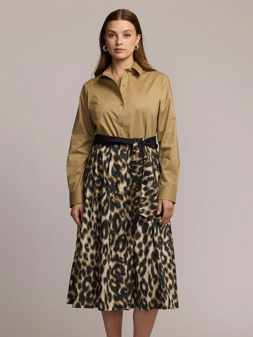 A woman stands against a plain background wearing the Hinson Wu Robin Long Sleeve Animal Print Dress in Khaki, crafted from premium cotton fabric.