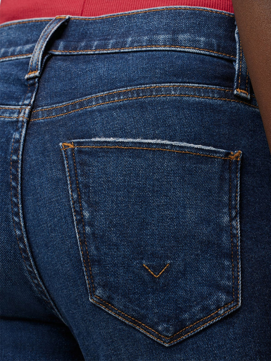 Close-up of a denim pocket on Hudson Nico Midrise Super Skinny Ankle Jean in Marigold.