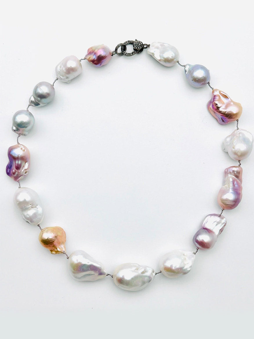 The JMNYC Designs 18" Ombre White/Grey Freshwater Baroque Pearl Necklace features large, irregularly shaped pearls in a gradient of white and grey tones, elegantly finished with a sparkling diamond clasp. This sophisticated piece combines unique colors and textures for a standout look.
