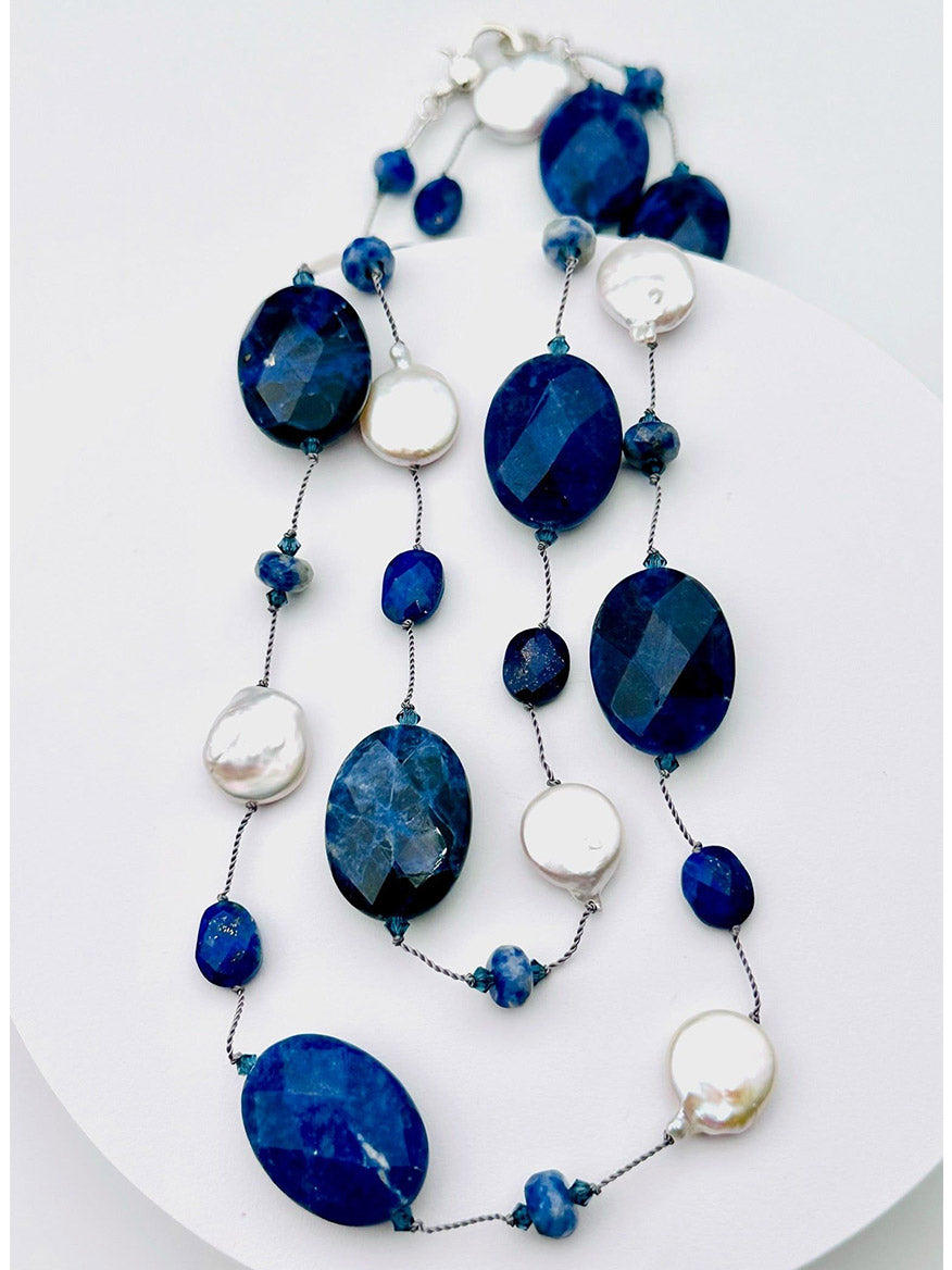 JMNYC Designs 36" Faceted Sodalite, Lapis & White Freshwater Coin Pearl Necklace featuring large oval blue stones, small round blue beads, and flat freshwater coin pearls on a silver chain, displayed on a white background.