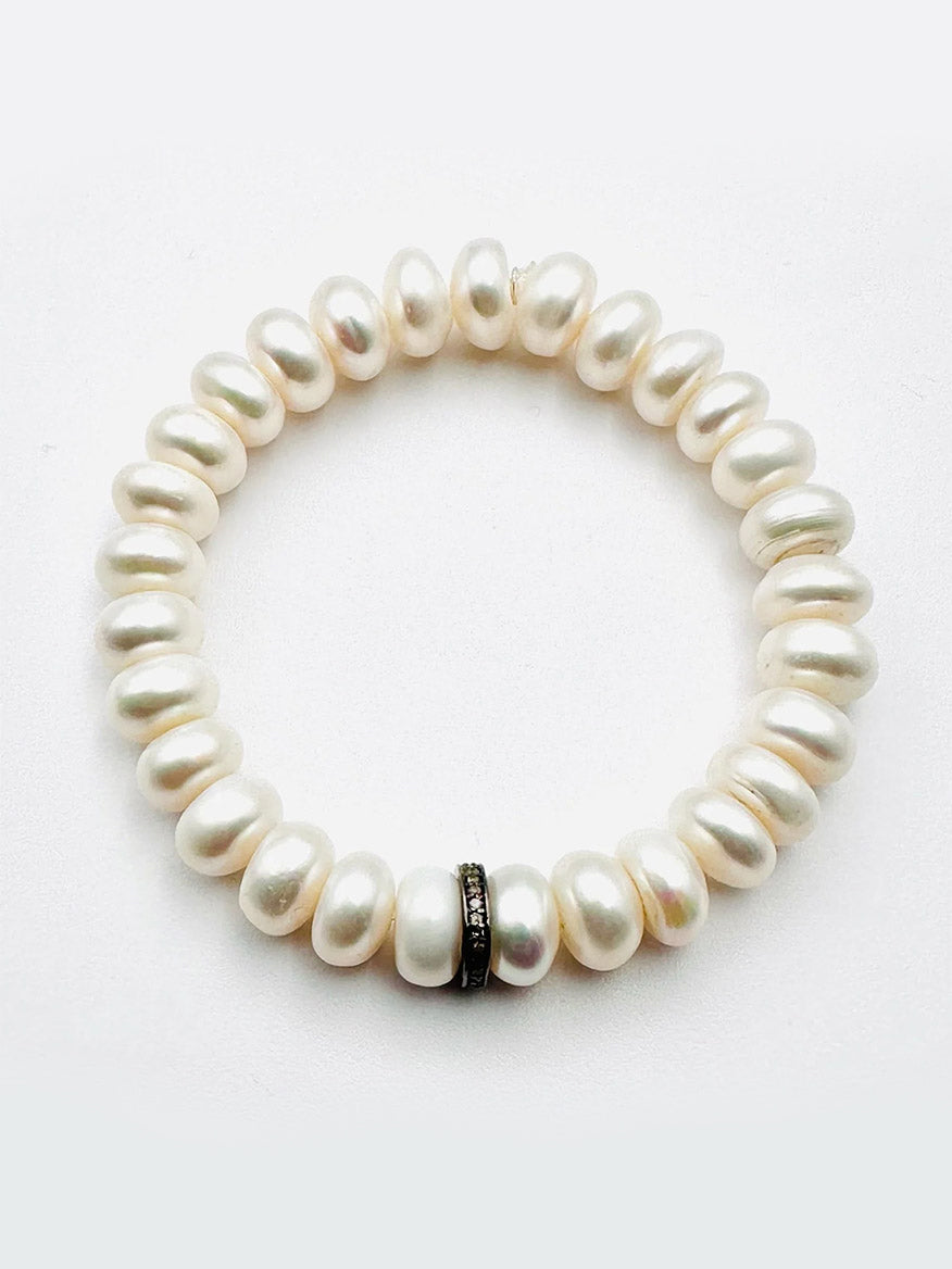 The JMNYC Designs Freshwater Button Pearl Bracelet features luminous white pearls and a sterling silver & diamond rondelle accent bead.