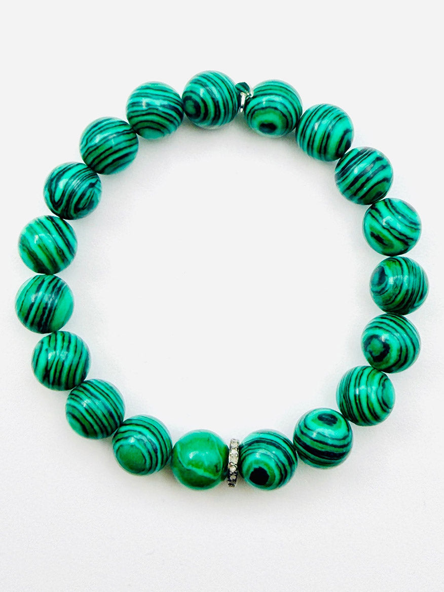 A JMNYC Designs Emerald Green Fordite Ball Bracelet with Diamond Rondelle featuring green and black striped round beads and a small silver accent, styled against a white background and evocative of an emerald green bracelet.