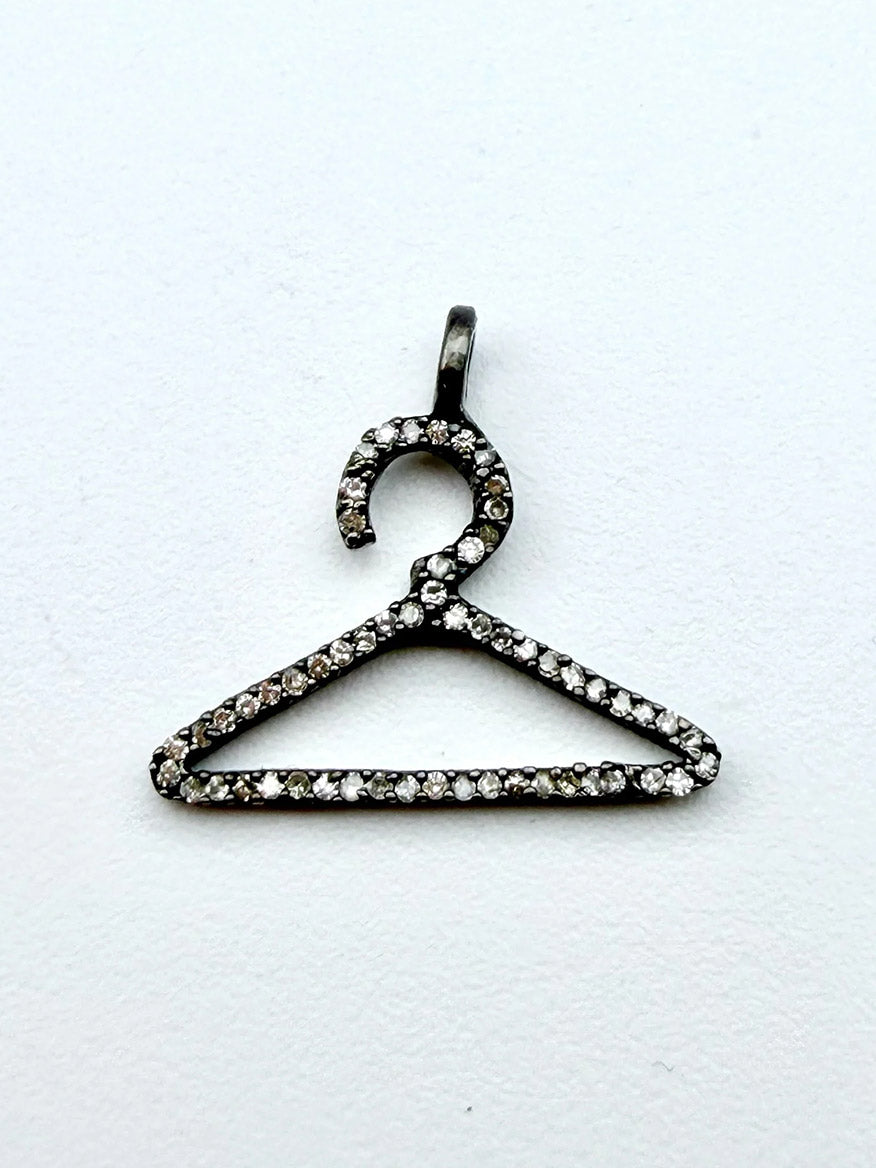 The JMNYC Designs Small Pave Diamond Sterling Silver Pendant, shaped like a clothes hanger and outlined with glittering pave diamonds, sits elegantly on a plain white background.