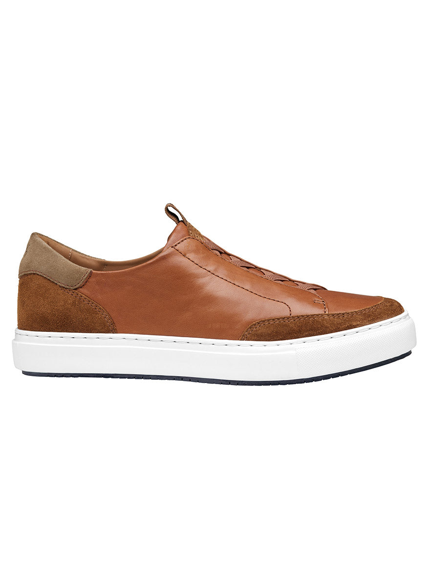 Side view of the J & M Collection Anson Stretch Lace-to-Toe Cognac English Suede/Sheepskin retro-style sneaker featuring a white rubber sole and cushioned EVA outsole, shown against a plain white background.