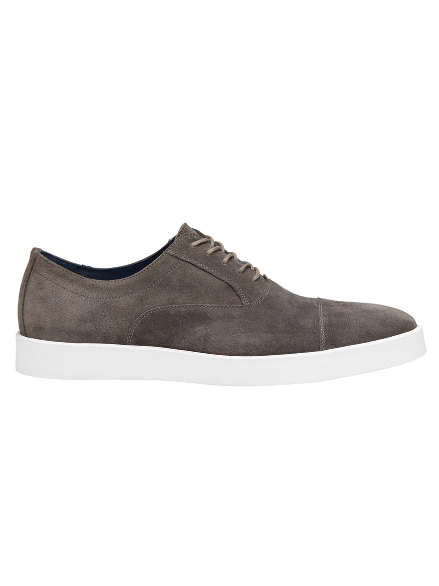 The J & M Collection Bolivar Cap in Gray Italian Suede is an elegant oxford shoe with a white rubber sole, featuring luxurious Italian suede and a removable footbed, showcased in a side profile view against a white background.