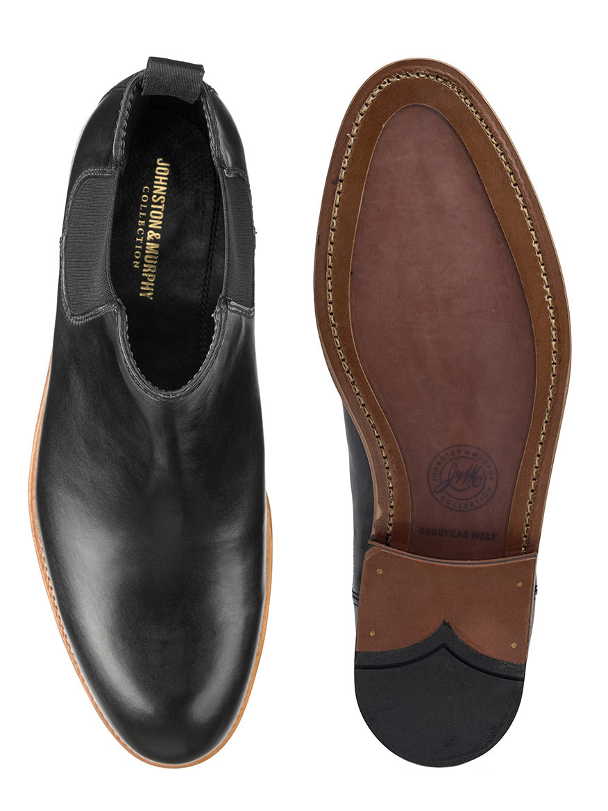 Top and bottom view of a black leather boot by J & M Collection. One shoe highlights the polished black dip-dyed calfskin upper, while the other showcases the stitched brown sole with Goodyear welt construction.