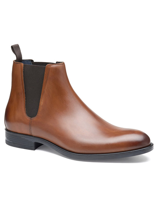 The J & M Collection Flynch Chelsea Boot in Tan Italian Calfskin features a single brown leather boot with an Italian calfskin upper, elastic side panel, pull tab, and black rubber outsole, viewed from the side.