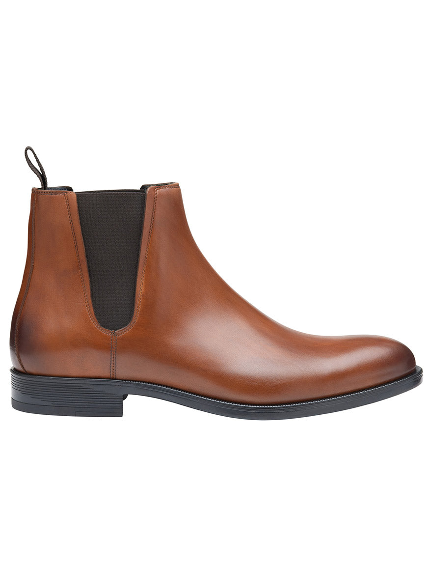 A side view of the J & M Collection Flynch Chelsea Boot in tan Italian calfskin, featuring a black elastic gusset and a black sole, crafted for premium quality.