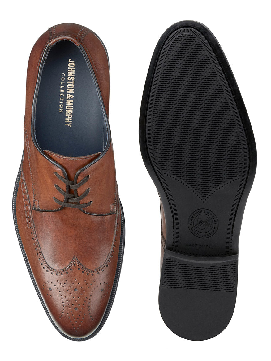 Pair of J & M Collection Flynch Wing in Tan Italian Calfskin by Johnston & Murphy, crafted from Italian calfskin and shown from the top and bottom view. The shoes feature laces, perforated detailing, leather linings, and rubber soles.