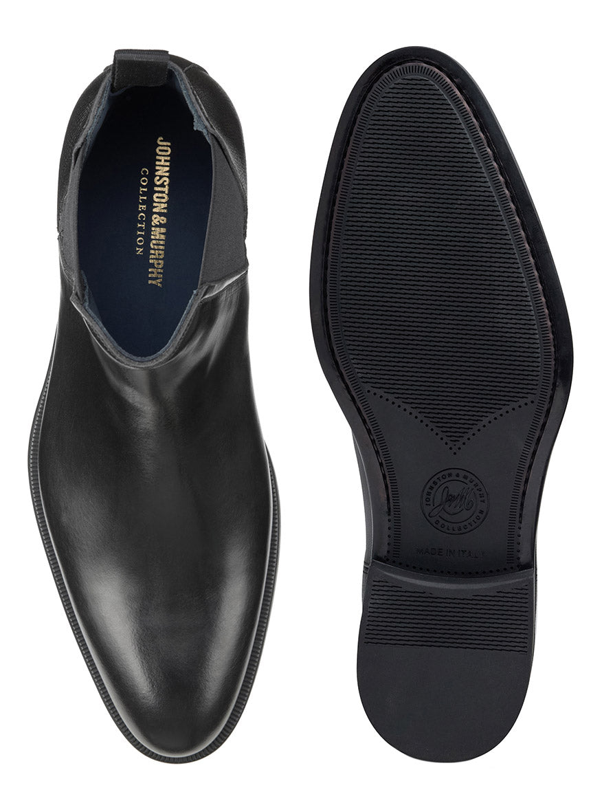 One J & M Collection Flynch Chelsea Boot in Black Italian Calfskin shown from the top, and another shown from the sole, with brand text visible inside on its soft leather lining and on the sole.
