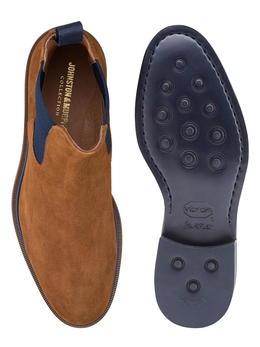Top and sole view of the J & M Collection Hartley Chelsea Boot in Snuff Italian Suede, featuring a black Vibram EVA rubber sole with circular traction pads and a blue elastic side panel. The interior boasts a leather-covered footbed for added comfort.