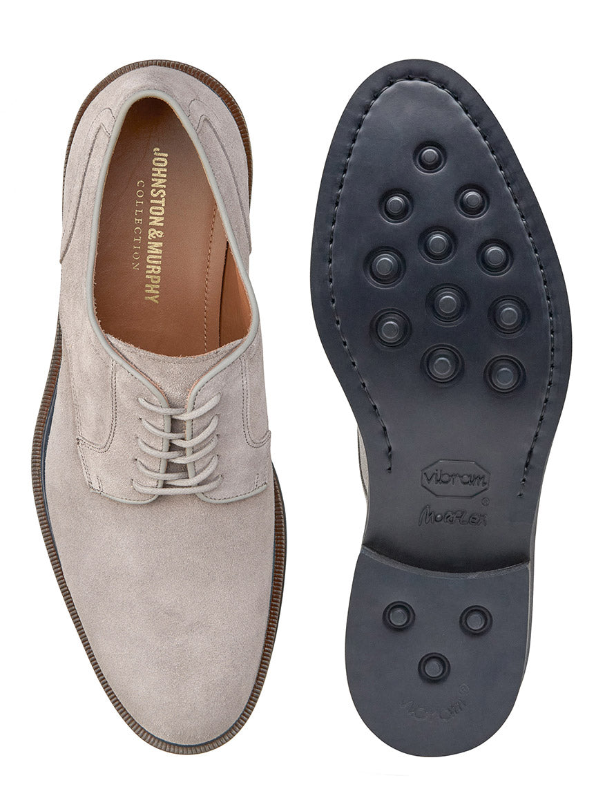 Pair of J & M Collection Hartley Plain Toe in Grey Italian Suede, displayed from top-view and bottom-view. The sole shows circular treads and features a Vibram EVA outsole labeled with "Vibram Morflex." "Johnston & Murphy" is inscribed inside the shoe, which includes luxurious leather lining.