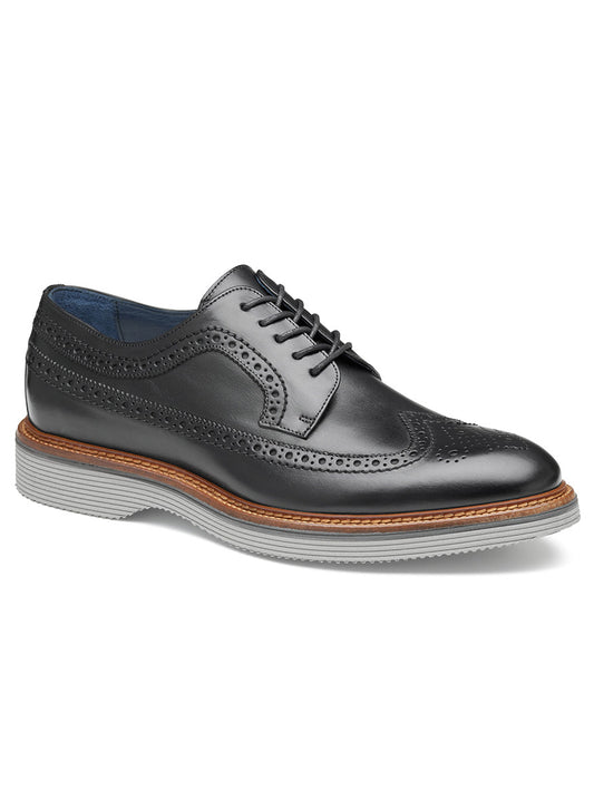 A J & M Collection Jenson Longwing in Black Italian Calfskin with decorative perforations, a brown welt, gray rubber sole, and an Italian calfskin upper, featuring a cushioned footbed for added comfort.