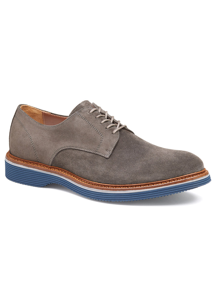 The J & M Collection Jenson Plain Toe in Grey Italian Suede features European suede uppers, a versatile brown and blue High Abrasion EVA outsole, a secure lace-up closure, and a sophisticated low heel.