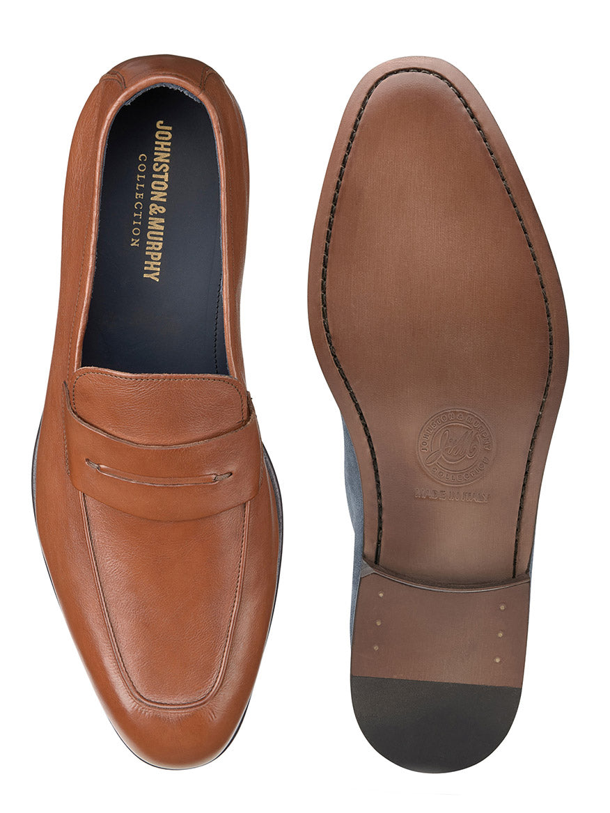 A pair of J & M Collection Taylor Penny in Tan Italian Calfskin loafers on a white background with ultra flexible construction and a leather outsole.