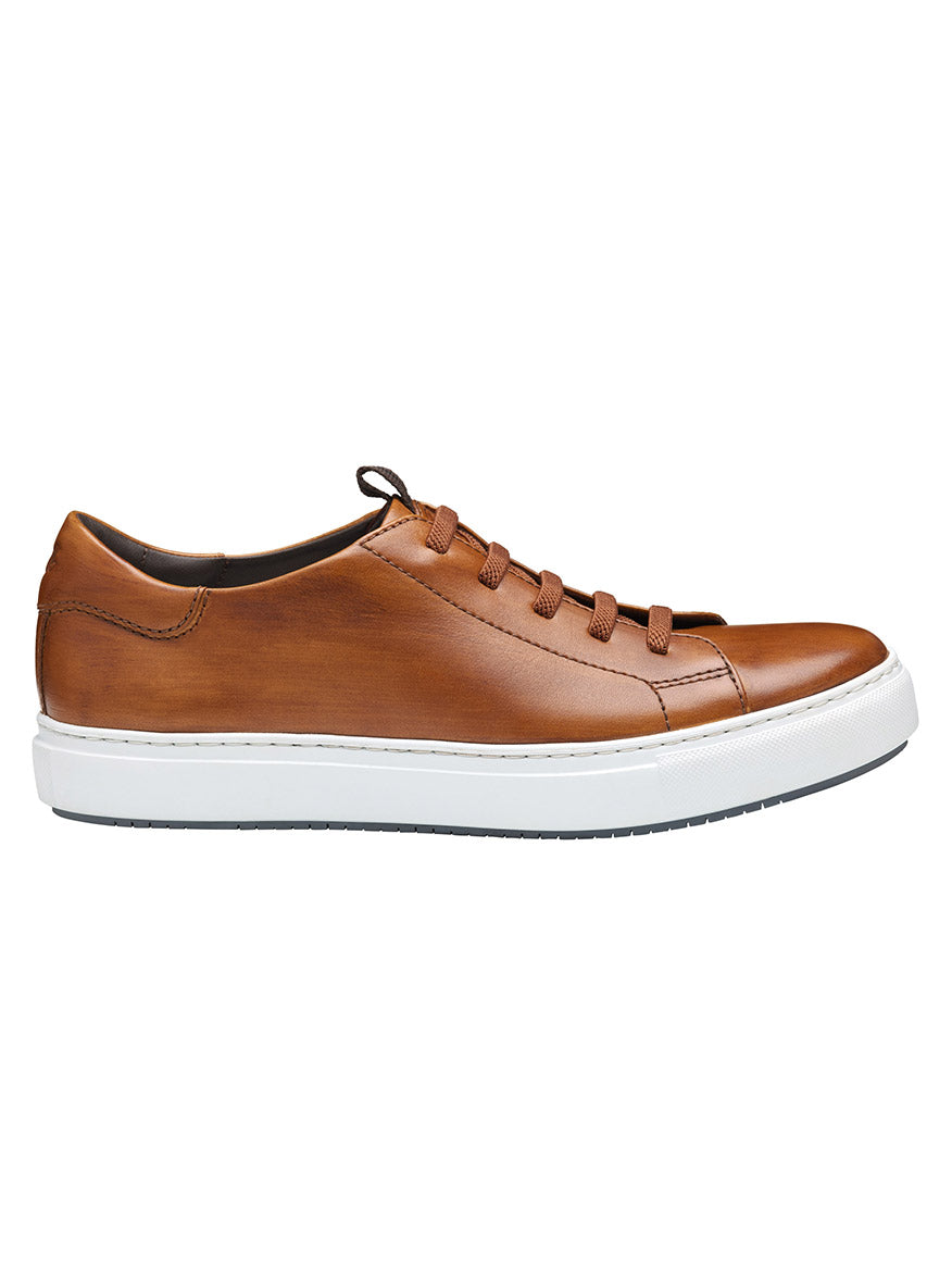 The J & M Collection Anson Lace-to-Toe sneaker features hand-stained brown calfskin leather, matching laces, and a white cushioned rubber sole; pictured in side profile on a plain background.