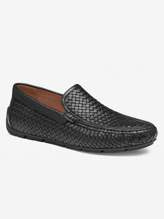 The J & M Collection Baldwin Driver Woven Slip-On in Black Sheepskin features a sleek design and cushioned footbed, viewed from the side.