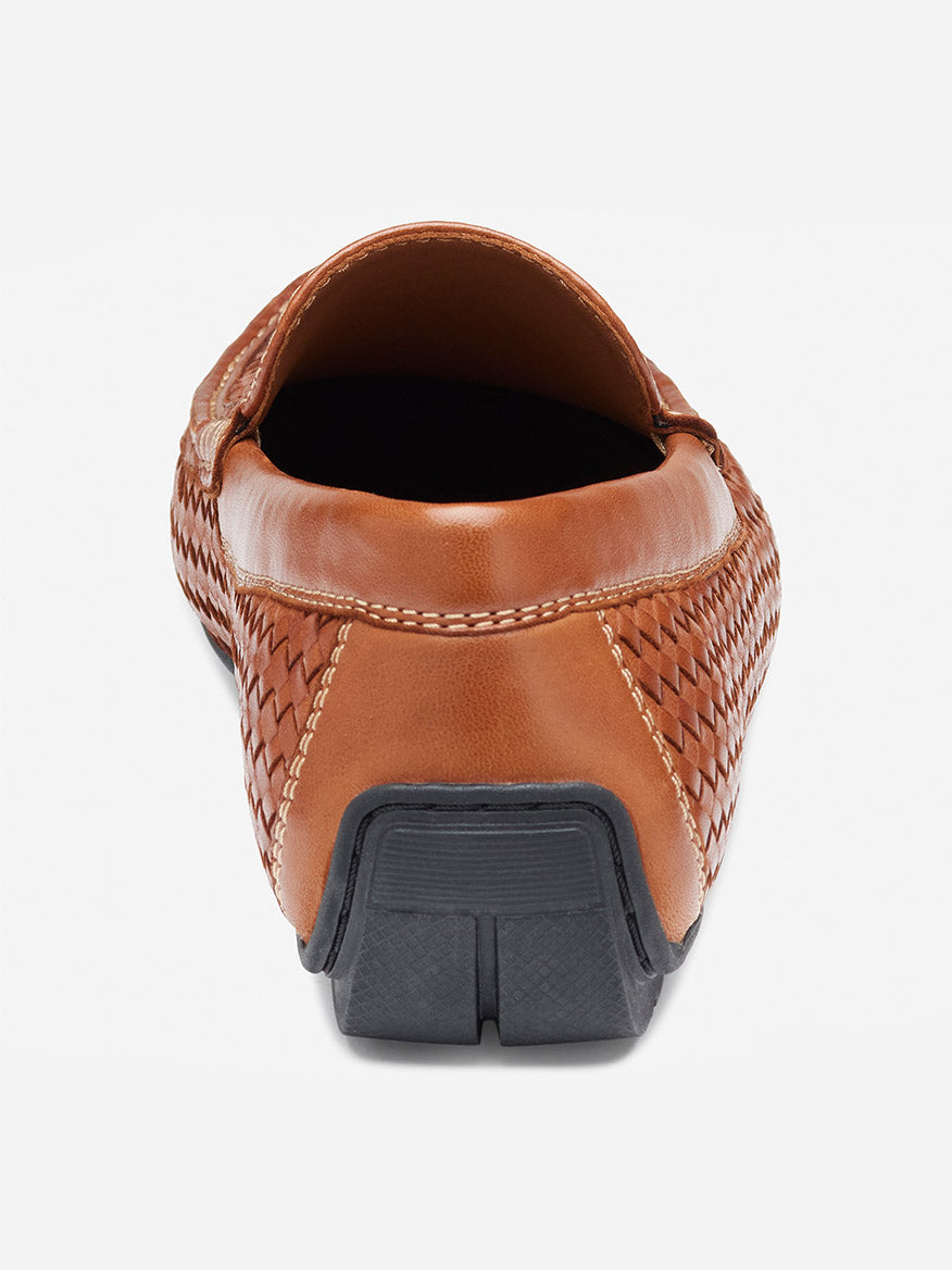 Back view of the J & M Collection Baldwin Driver Woven Slip-On in tan sheepskin, showcasing moccasin construction and a black rubber sole on a plain white background.