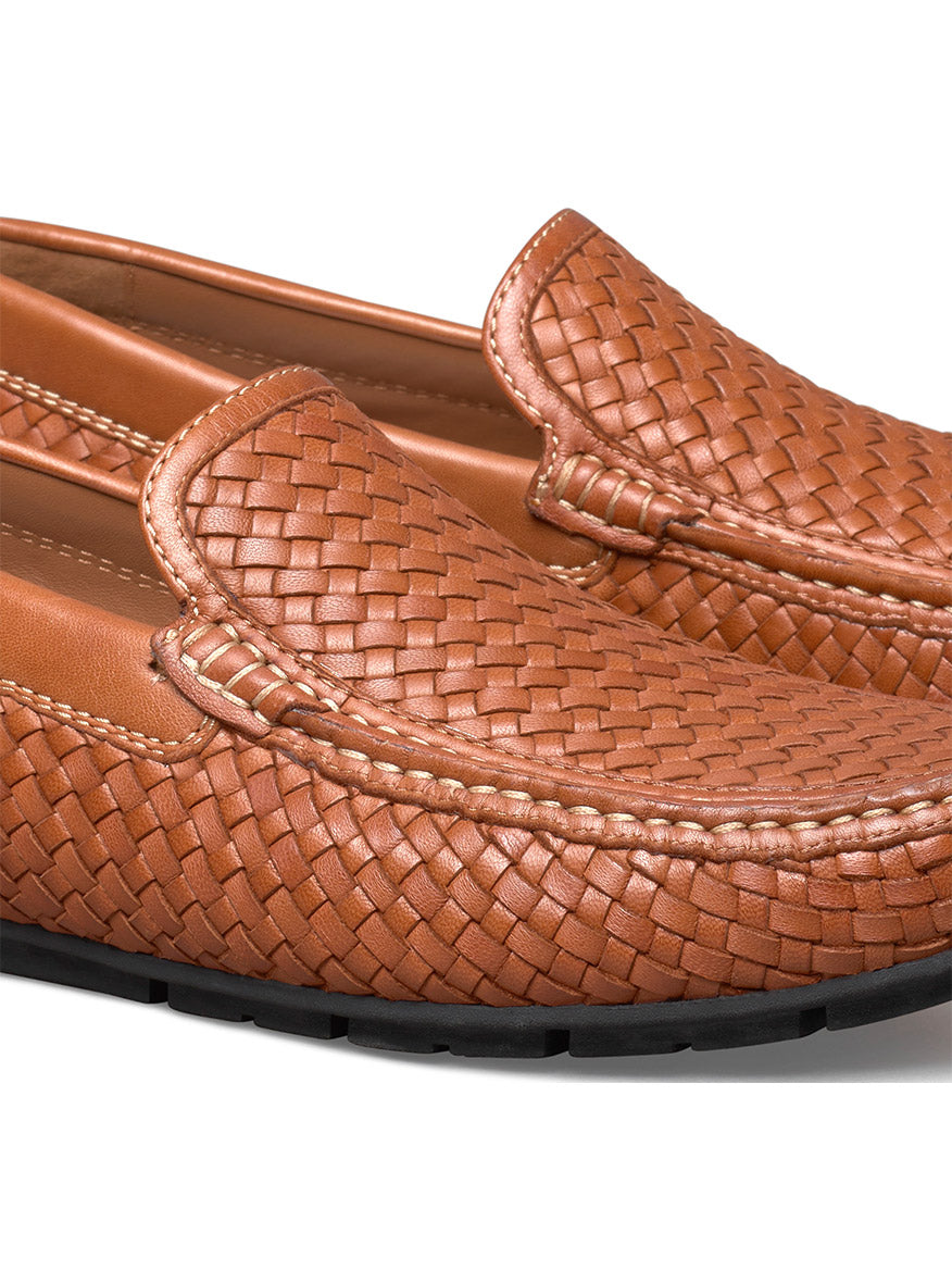 Close-up of J & M Collection Baldwin Driver Woven Slip-On in tan sheepskin leather with black soles. These loafers have a slip-on design, visible stitching details, and a cushioned footbed for added comfort.