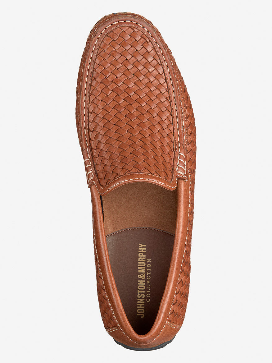 The J & M Collection Baldwin Driver Woven Slip-On in tan sheepskin by Johnston & Murphy features a cushioned footbed and displays its inner sole with the brand's name elegantly from an overhead view.