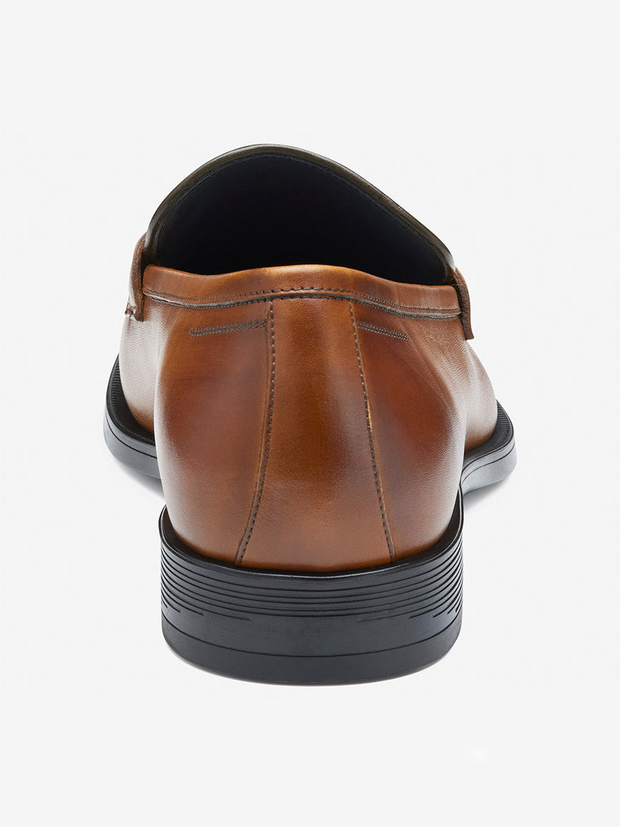 Close-up of the J & M Collection Flynch Braided Strap Loafer in Tan Italian Calfskin, showcasing a black heel, intricate stitching, and sleek design.
