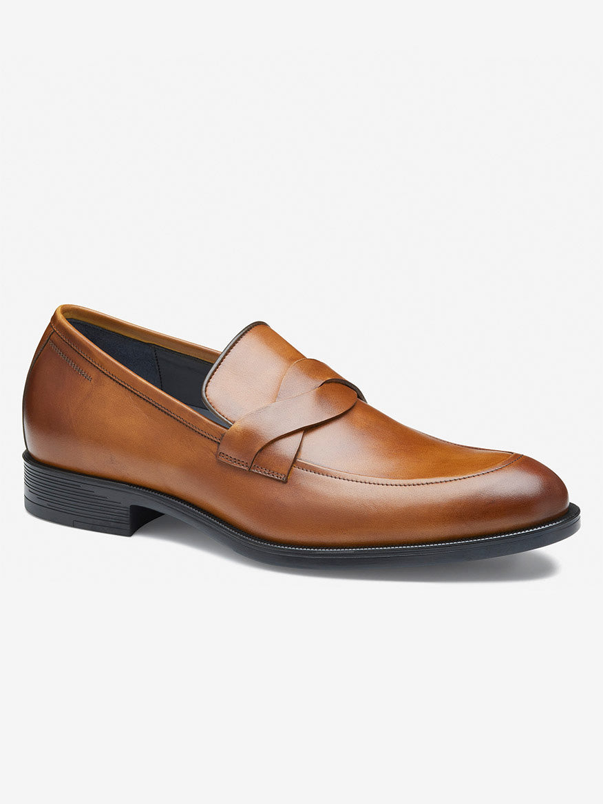 The J & M Collection Flynch Braided Strap Loafer features a sleek design in tan Italian calfskin, a low heel, and a braided strap on top for added style, complemented by a leather-covered footbed for comfort.