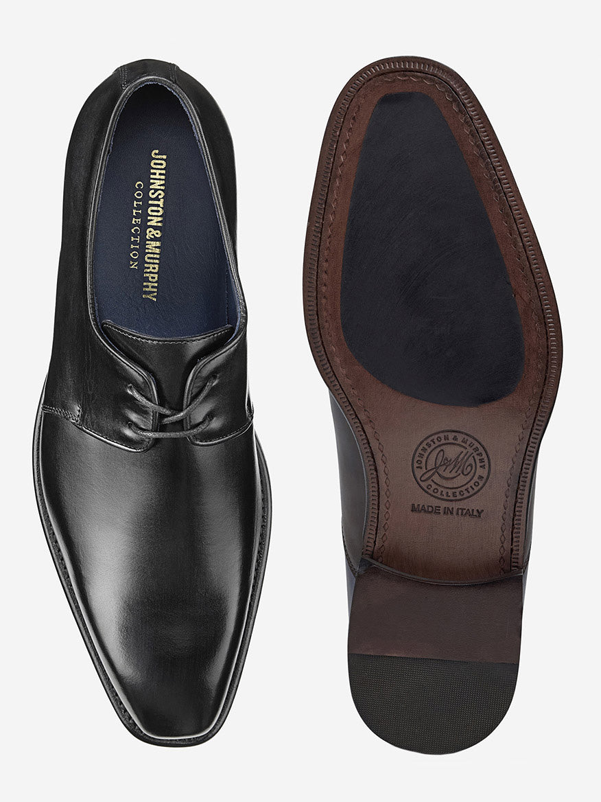 The J & M Collection Larson 2-Eye Plain Toe in Black Italian Calfskin showcases one shoe from above and the other from below, with its sole branded and labeled "Made in Italy," exemplifying exquisite handcrafted craftsmanship.