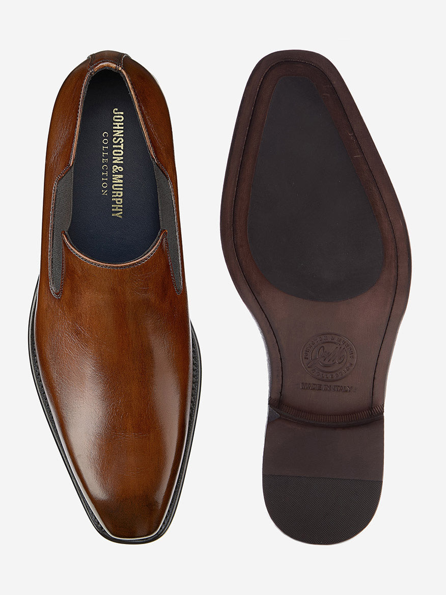 The J & M Collection Larson Slip-On in Mahogany Italian Calfskin is handcrafted from fine materials with a visible sole and comfort innovations, delivering style and ease for any occasion.
