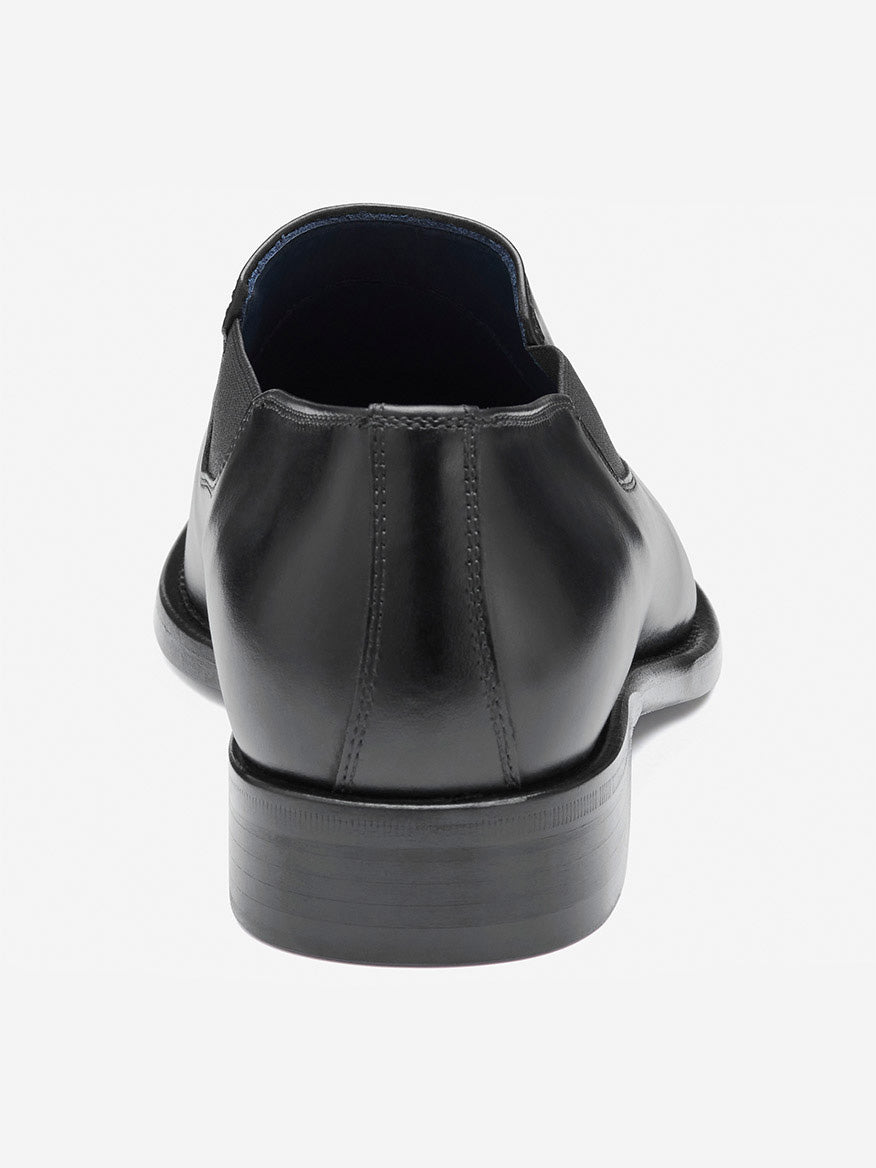 Rear view of the J & M Collection Larson Slip-On, a black Italian calfskin dress shoe with exquisite craftsmanship and detailed stitching, featuring a smooth heel, elegantly set against a plain white background.